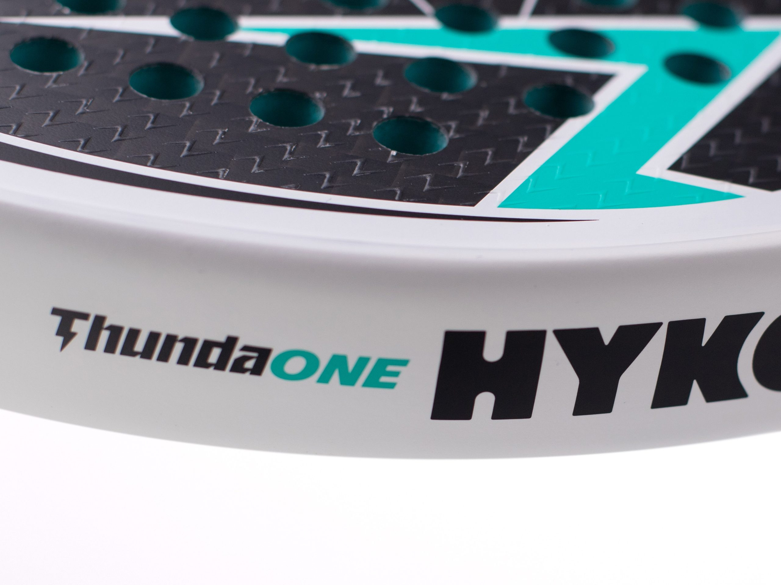 Close-up of a teal and black sports sticker with a perforated texture and the text'Thunder ONE' visible in teal and black lettering.